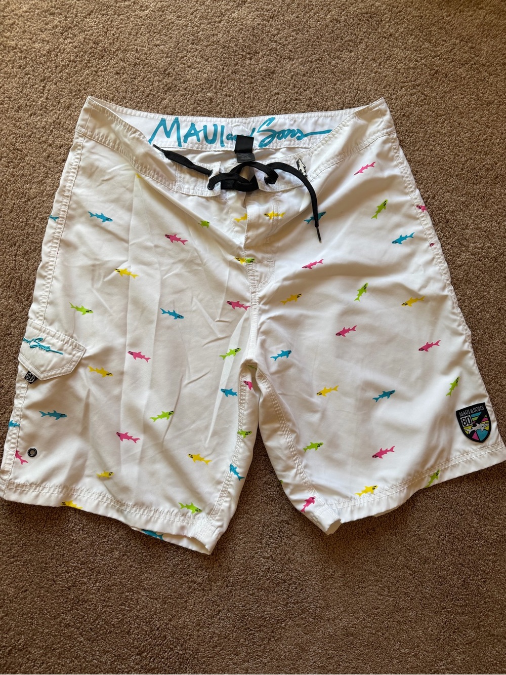 Maui and Sons White Swim Shorts with Teal Script and Multicolor Sharks